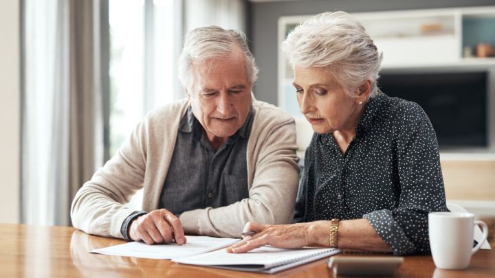 Elders reading out of a notebook
