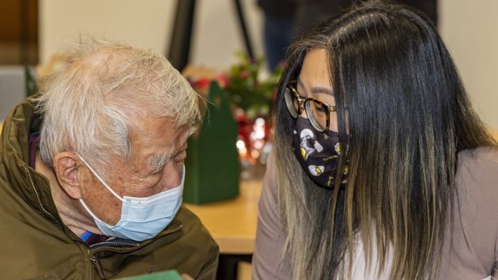 Senior talking to his adult granddaughter
