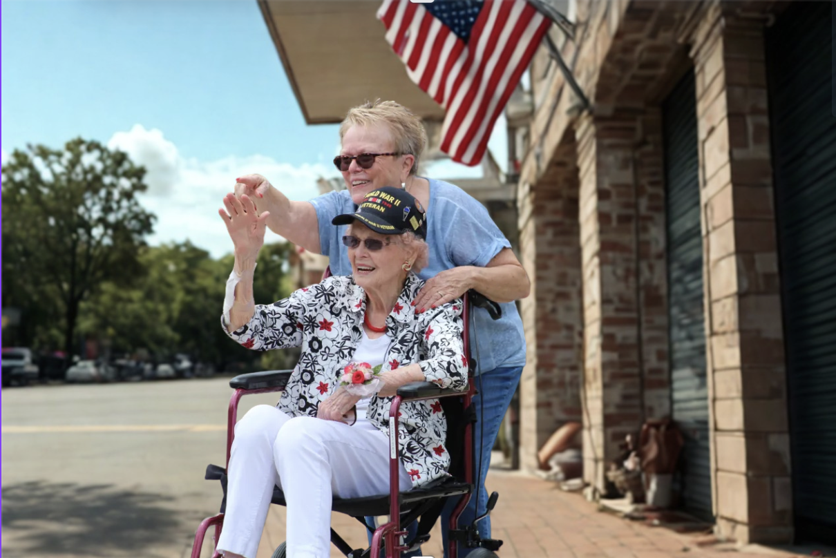 Veteran Woman in wheelchair with daughter pushing her
