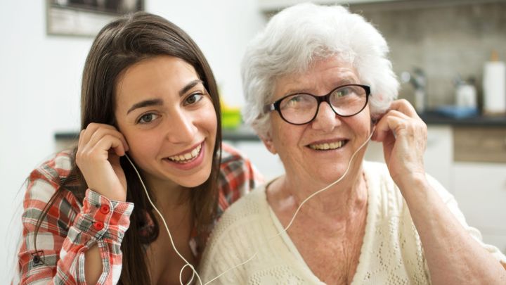 Daughter and Elderly Mother using earbuds