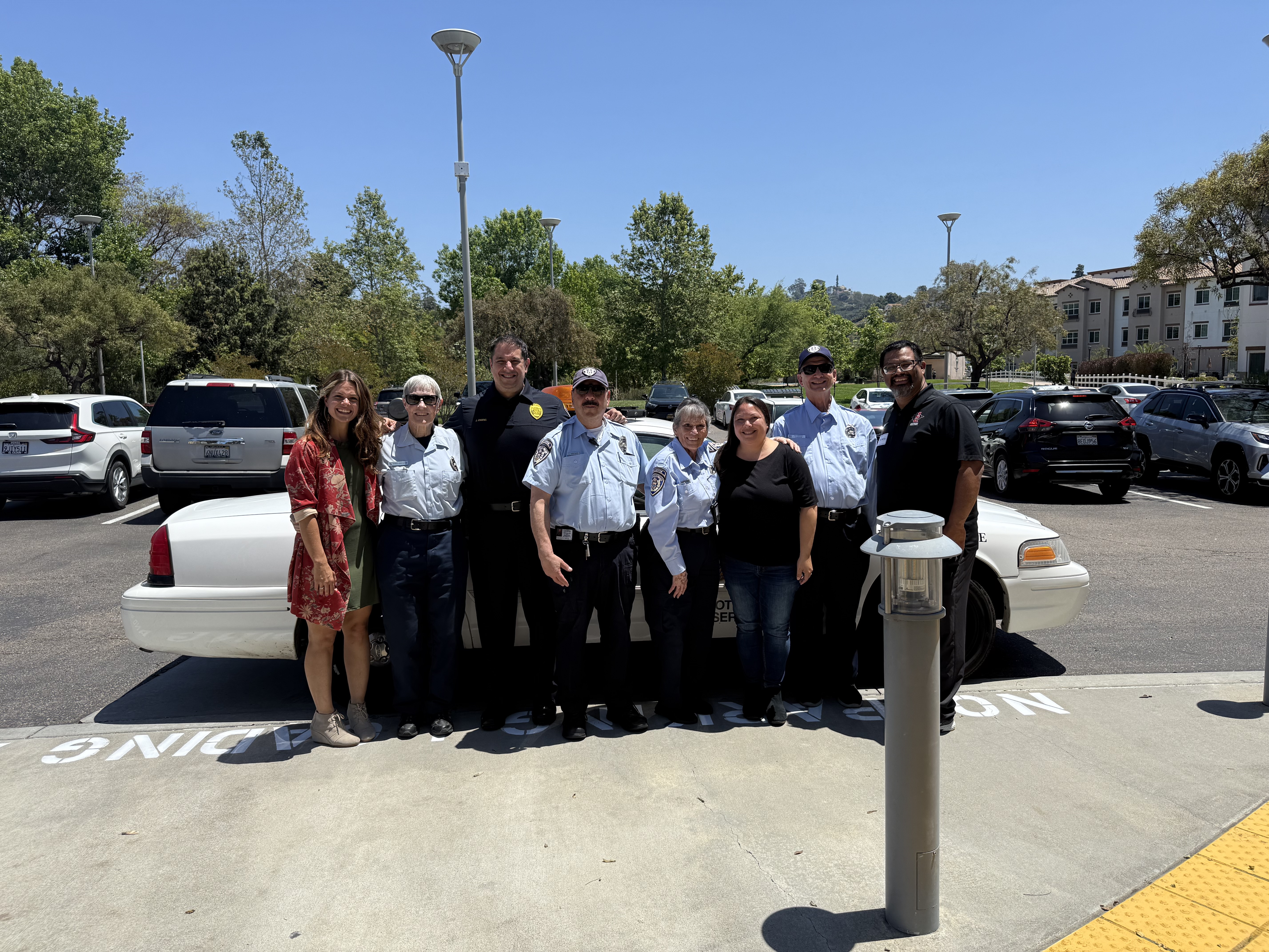 Group of people posing for a photo outside