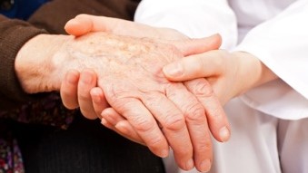 Elderly hand being examined by a doctors hand