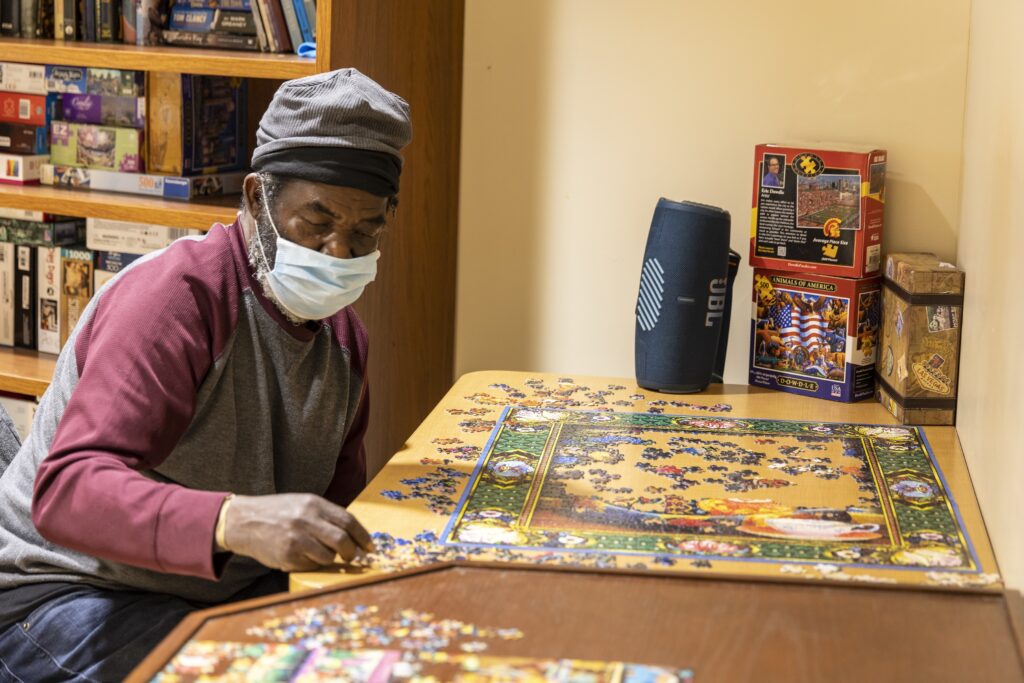 Elderly man putting together a puzzle