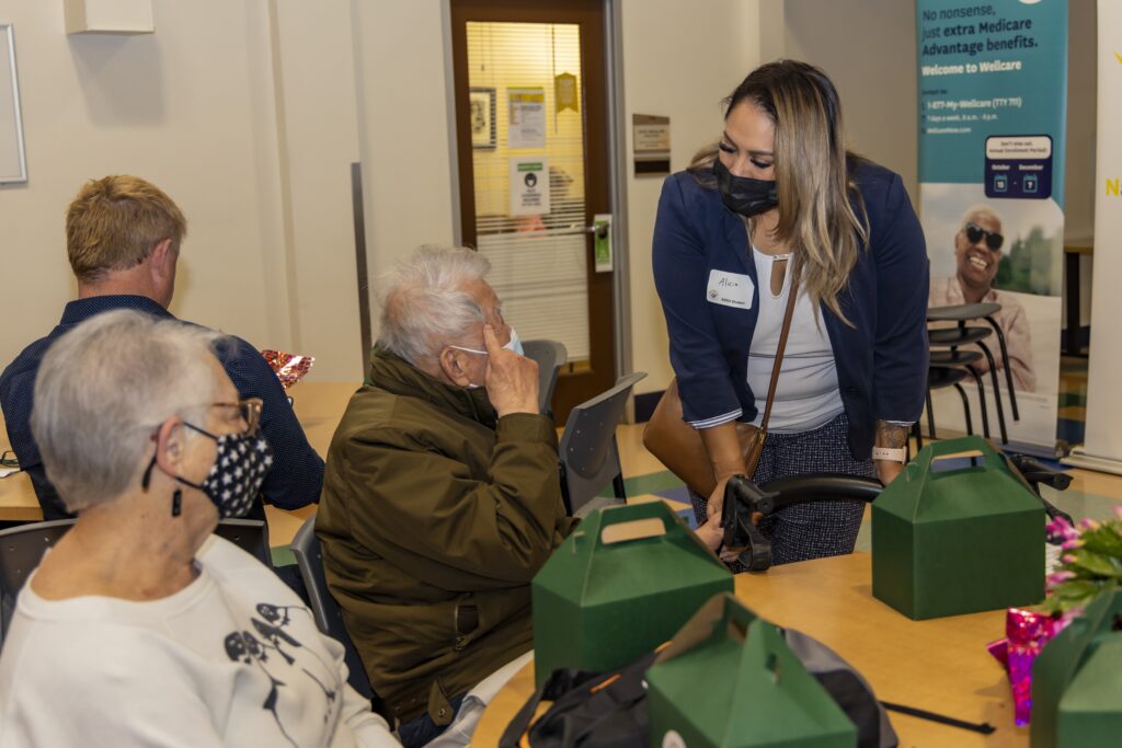 SDSU student talking to elderly members at the Healthnet event