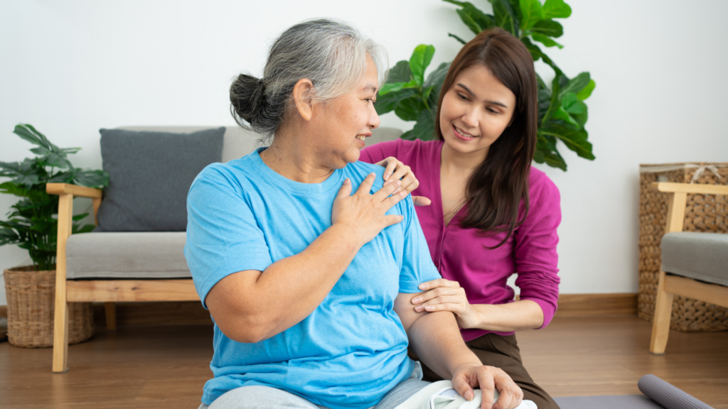 Caregiver helping patient with stretching exercises