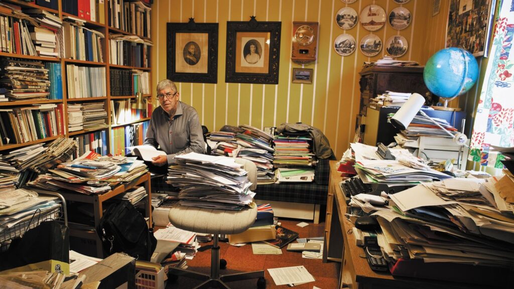 Man in disorganized office