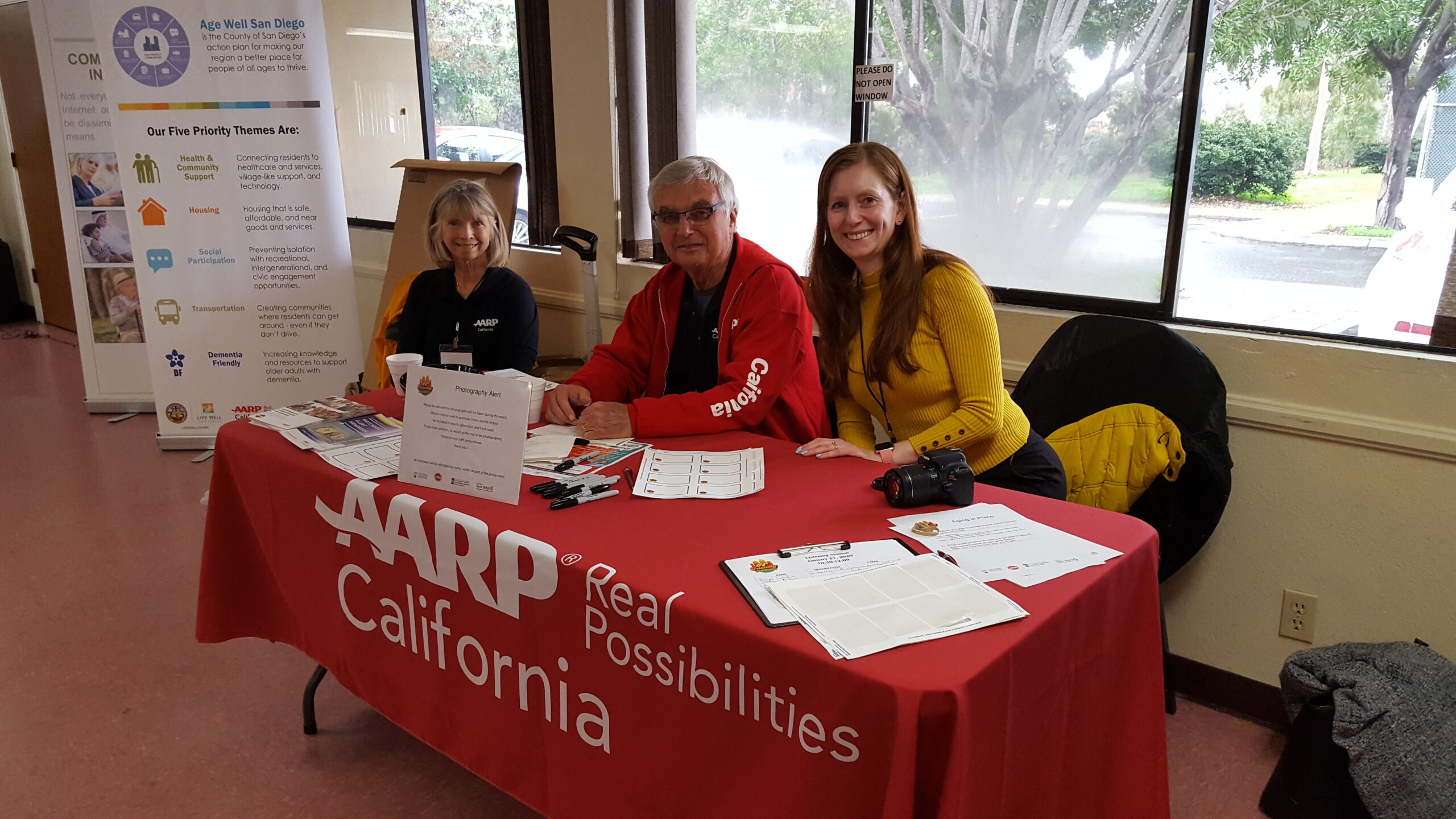 Staff and Volunteers at an AARP Check in Table