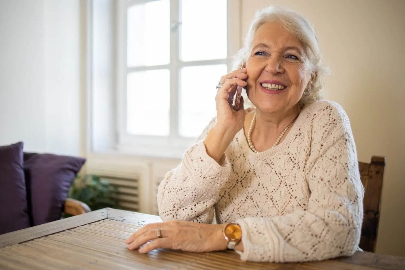 Senior Smiling while using her smartphone